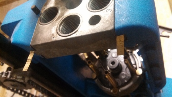 Image showing brass shims inserted on top of the toolhead of a Dillon 650